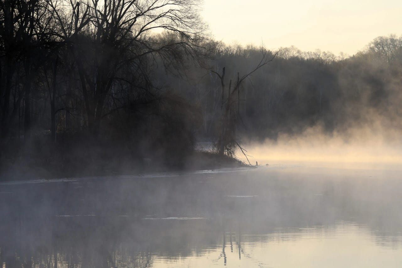 Sea smoke over a pond at sunrise